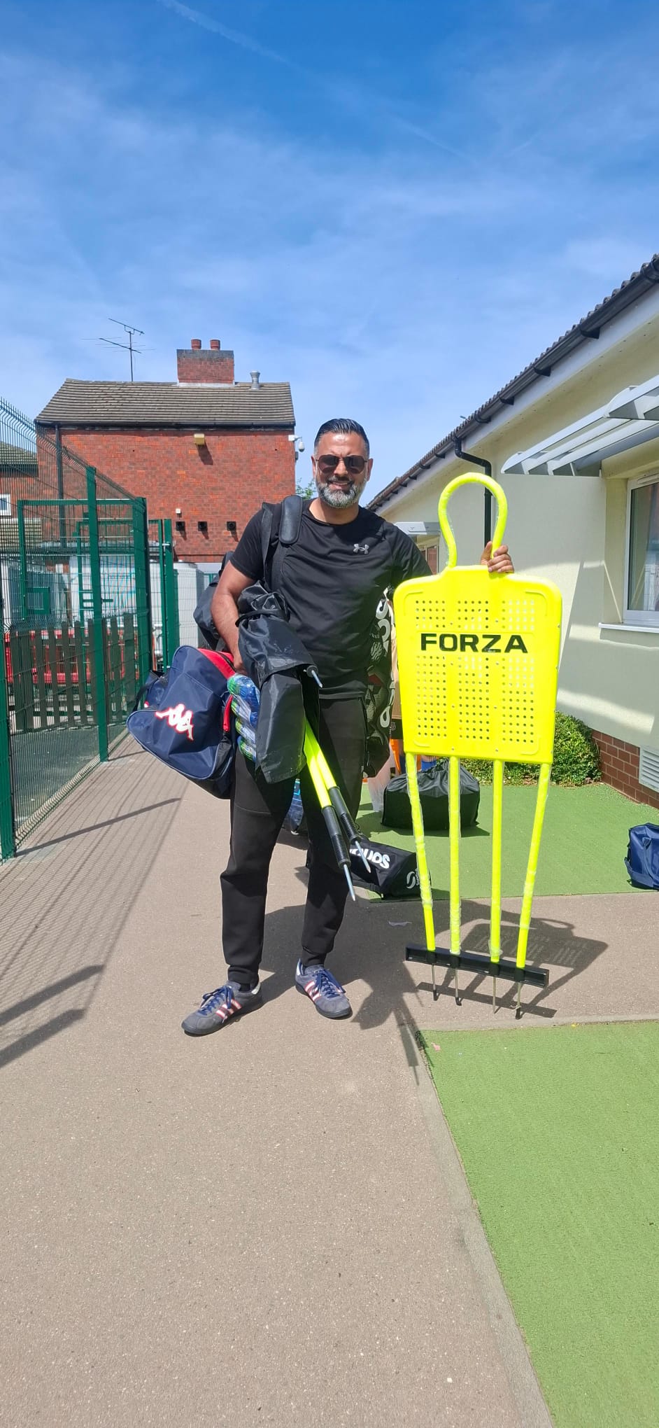 Imran Ali, founder and head coach of Active Goals Football, with training kit and a FORZA mannequin before a session