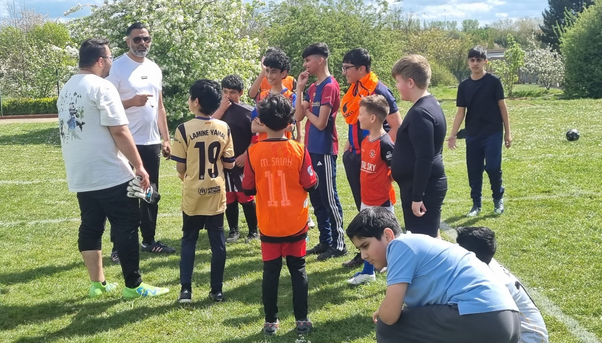 Coach Imran talking tactics with young players during a Saturday session at Wigmore Primary School